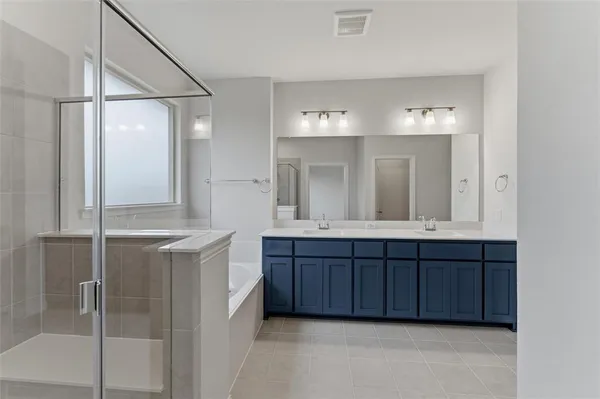 a bathroom with a double vanity sink and mirror