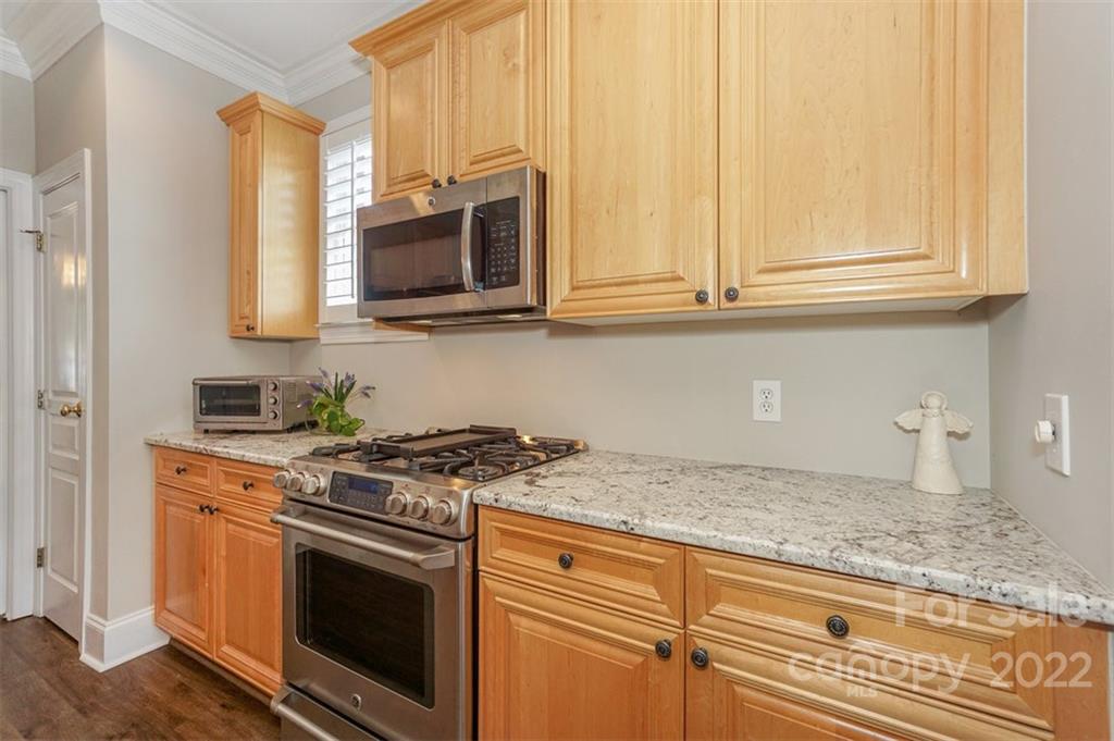 20025 North Cove Road Cornelius, NC 28031 - Photo 21 of 45 a kitchen with stainless steel appliances granite countertop white cabinets and a stove top oven