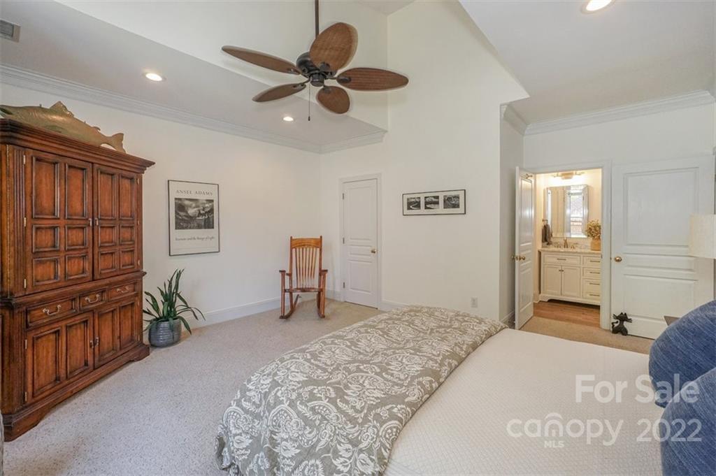 20025 North Cove Road Cornelius, NC 28031 - Photo 26 of 45 a bedroom with a bed and a chandelier