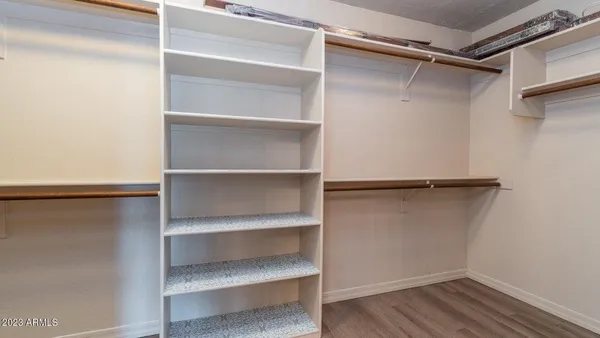a view of walk in closet with empty racks