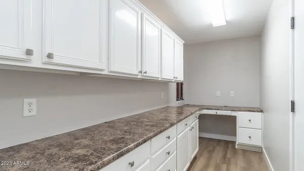 a view of cabinets with wooden floor