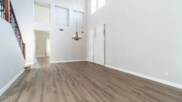 a view of a hallway with wooden floor and staircase