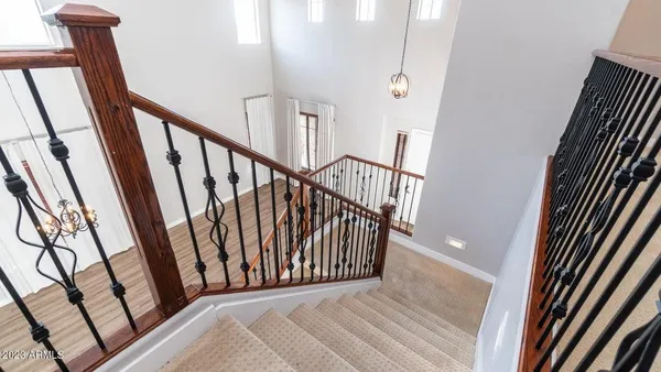 a view of a hallway with wooden floor and stairs
