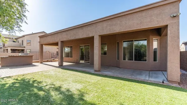 a view of a house with backyard porch and sitting area