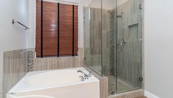 a bathroom with a bathtub and shower