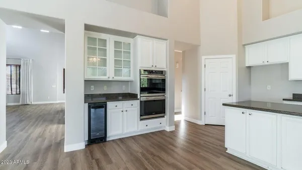 a kitchen with granite countertop a stove and a wooden floors