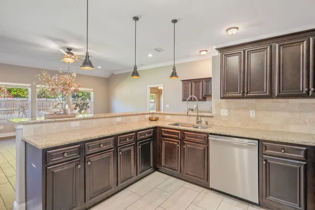 a kitchen with a sink stove and oven
