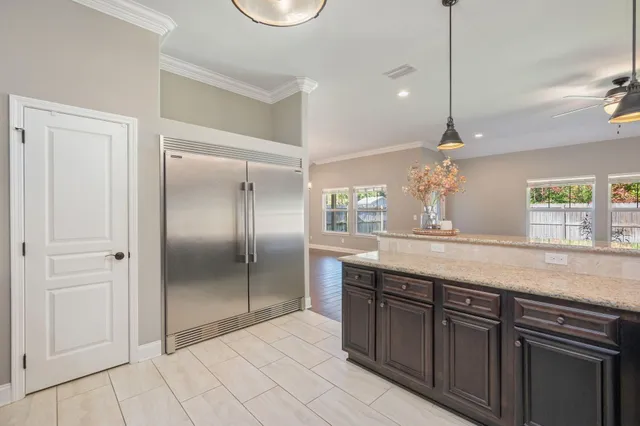 a bathroom with a granite countertop sink a mirror and a shower