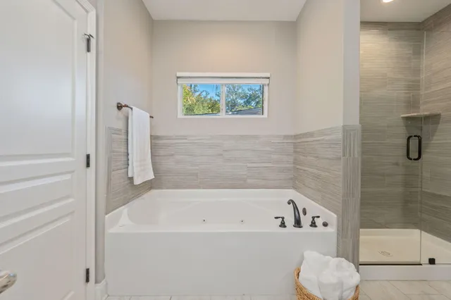 a bathroom with a bathtub and a shower