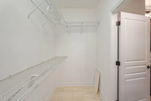 a view of walk in closet with empty racks