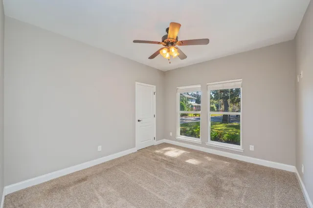 an empty room with windows and natural light