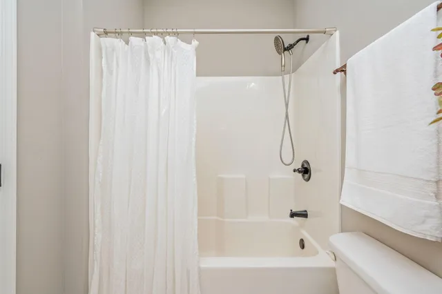 a bathroom with a shower and a bath tub