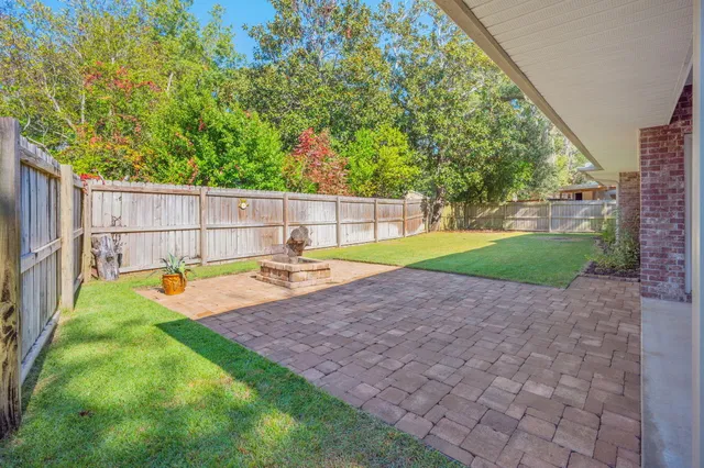 a view of a backyard with swimming pool