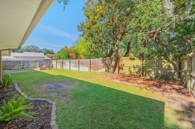 a view of a house with backyard and a tree
