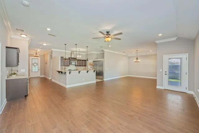 a view of a kitchen with a sink and a refrigerator