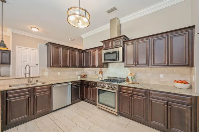 a kitchen with a sink cabinets and stainless steel appliances
