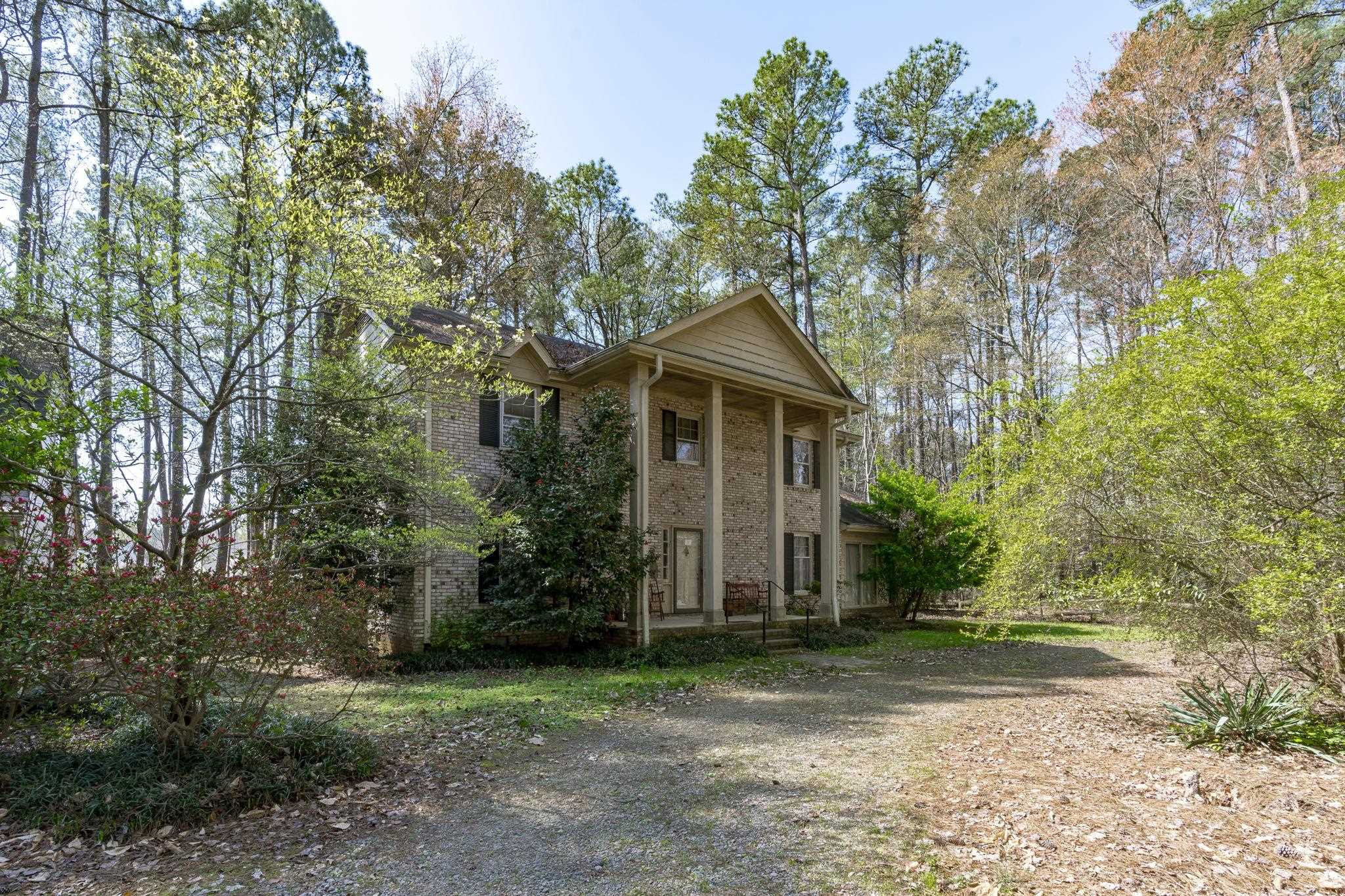 12801 Strickland Road Raleigh, NC 27613 - Photo 12 of 27 a front view of a house with a yard and trees