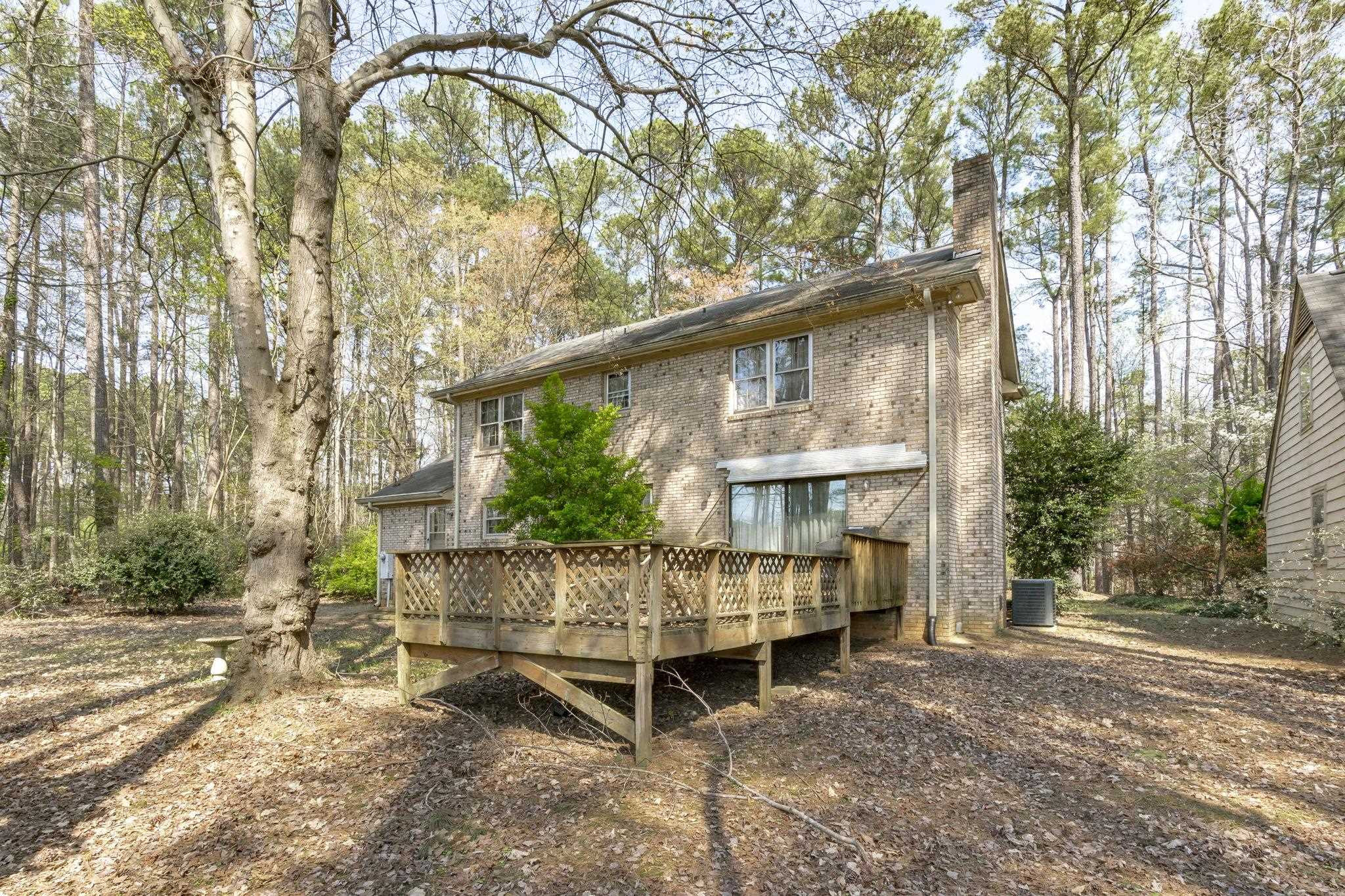 12801 Strickland Road Raleigh, NC 27613 - Photo 15 of 27 a wooden bench sitting in front of a building