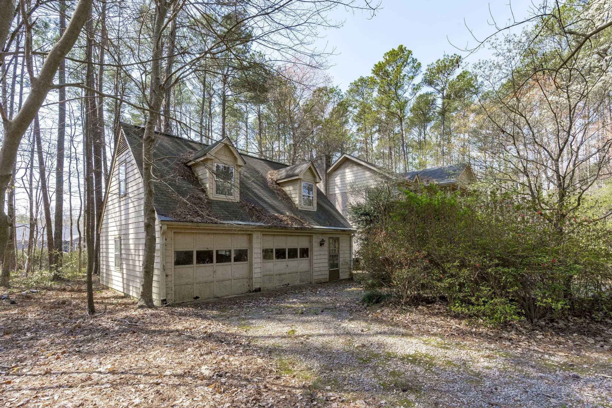 12801 Strickland Road Raleigh, NC 27613 - Photo 16 of 27 a front view of a house with a garden