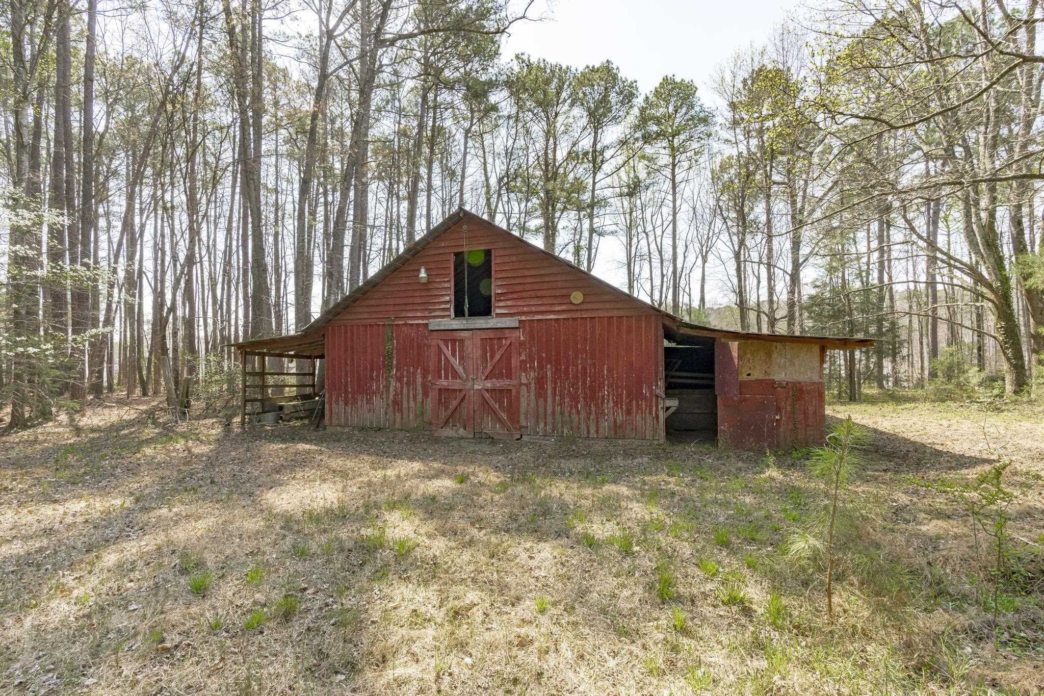 12801 Strickland Road Raleigh, NC 27613 - Photo 19 of 27 a view of a barn in the middle of a yard