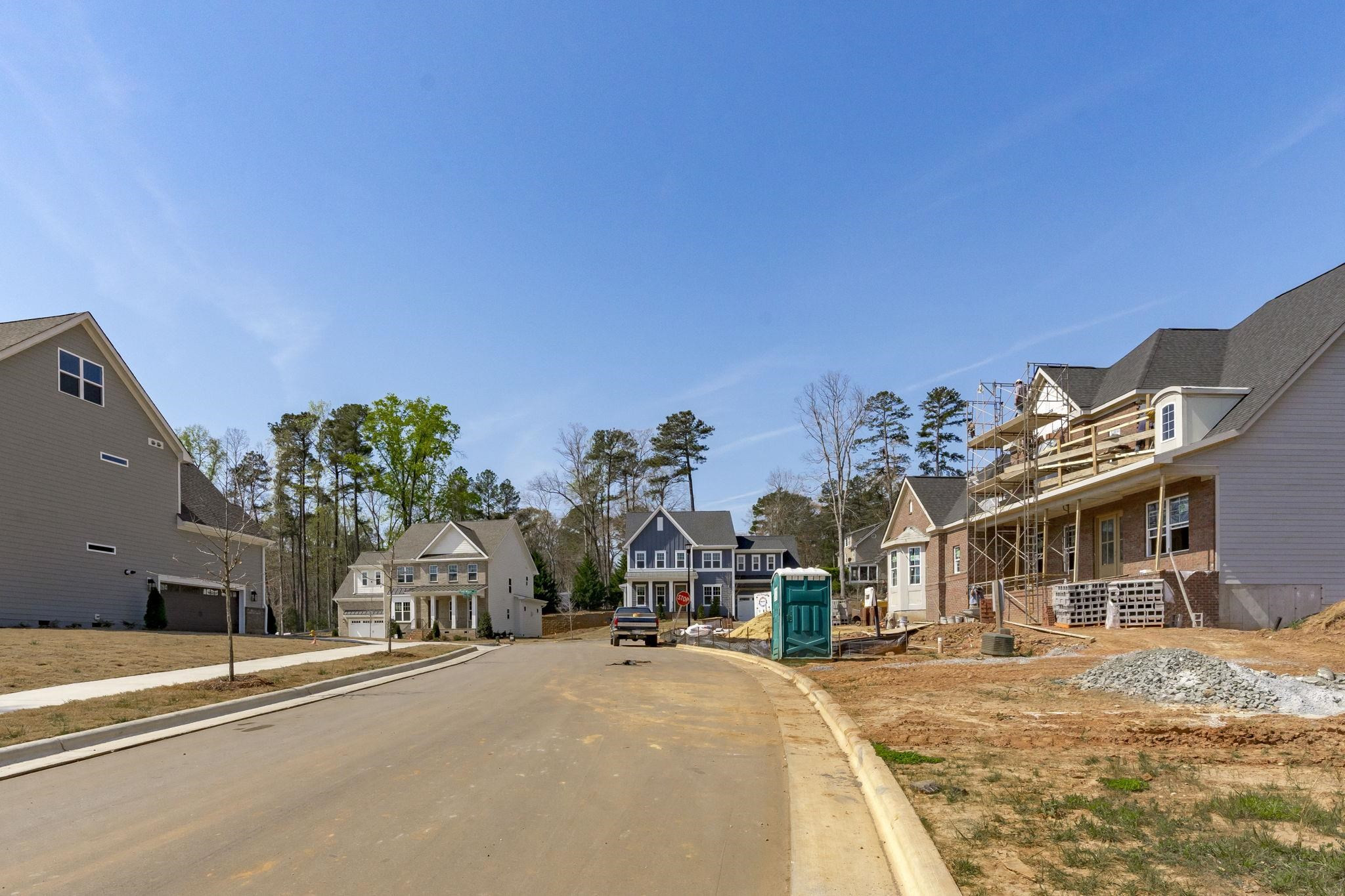 12801 Strickland Road Raleigh, NC 27613 - Photo 25 of 27 a front view of a house with a yard and a car park