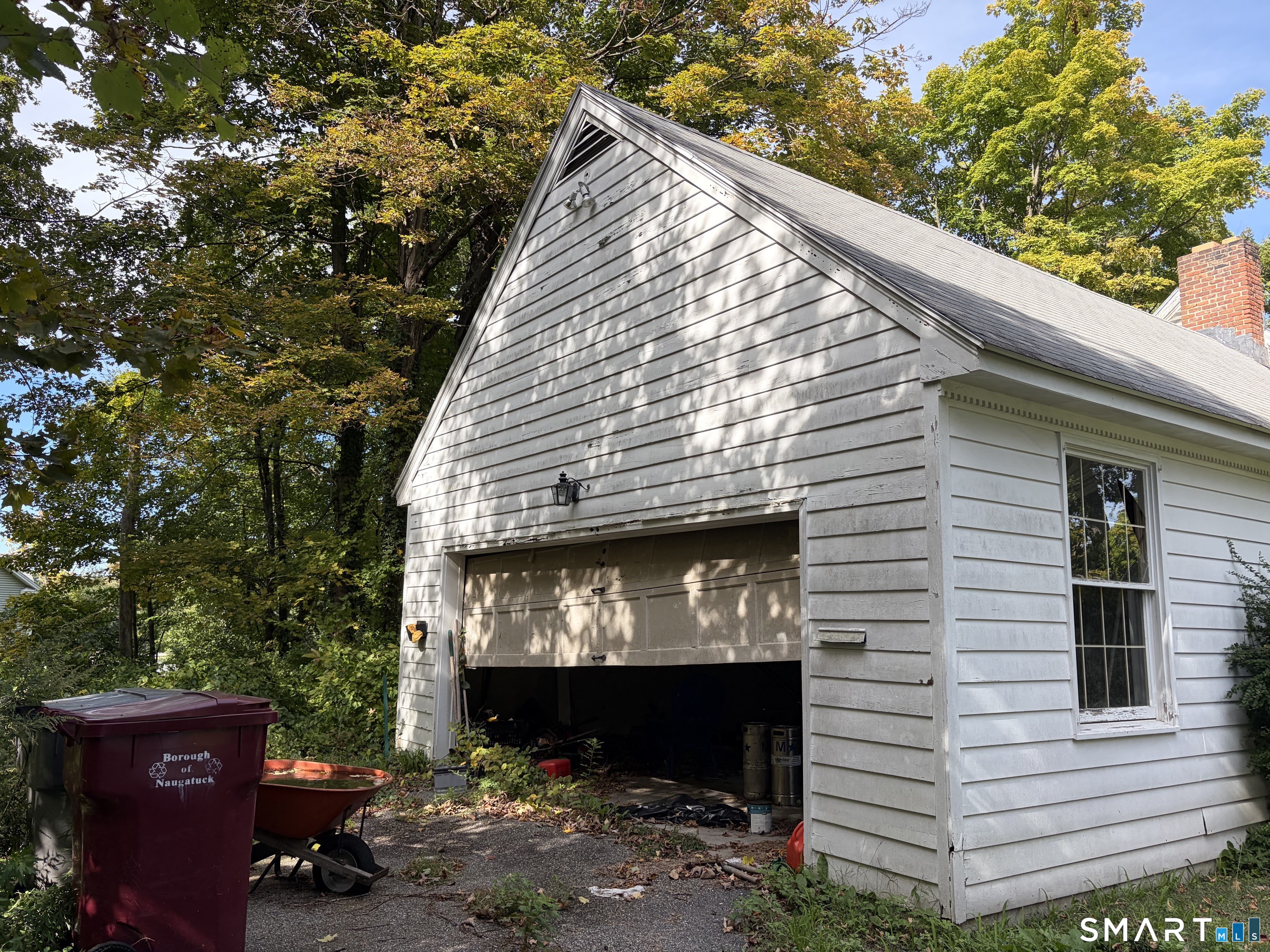 There is an oversized garage with stairs to a walk-up storage area.
