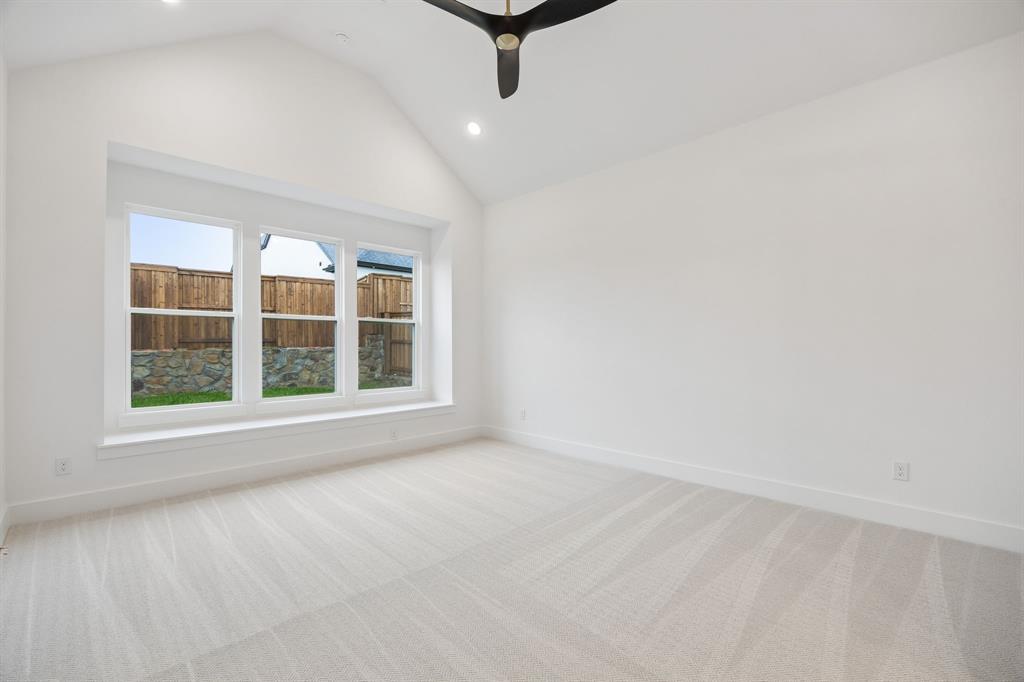 1120 Whirlabout Road Prosper, TX 75078 - Photo 12 of 25 Rest and relaxation await in this dreamy owner's suite featuring built in window seat, high ceilings and plush carpet.