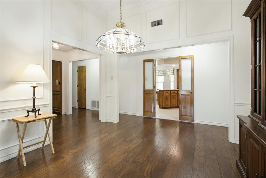 2905 Valleyview Drive Grapevine, TX 76051 - Photo 3 of 12 a view of a livingroom with wooden floor and a chandelier