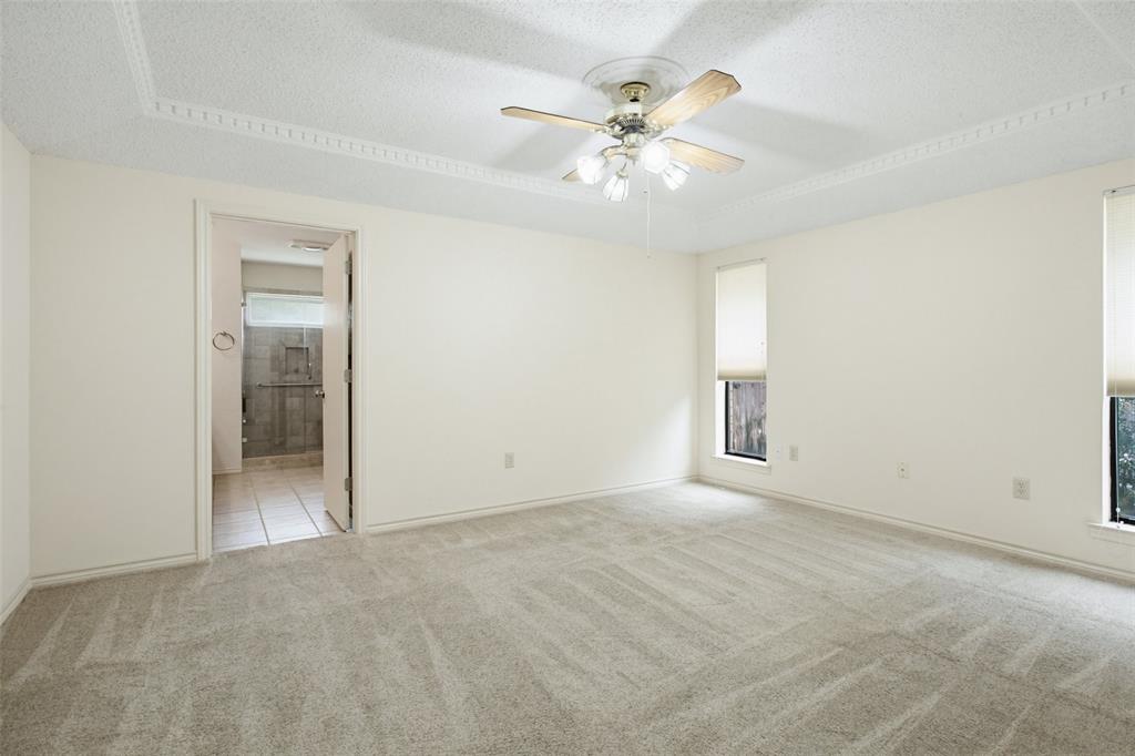 2905 Valleyview Drive Grapevine, TX 76051 - Photo 7 of 12 an empty room with chandelier fan and windows