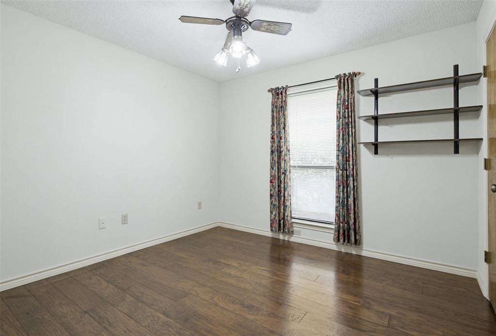 2905 Valleyview Drive Grapevine, TX 76051 - Photo 9 of 12 an empty room with wooden floor closet and windows