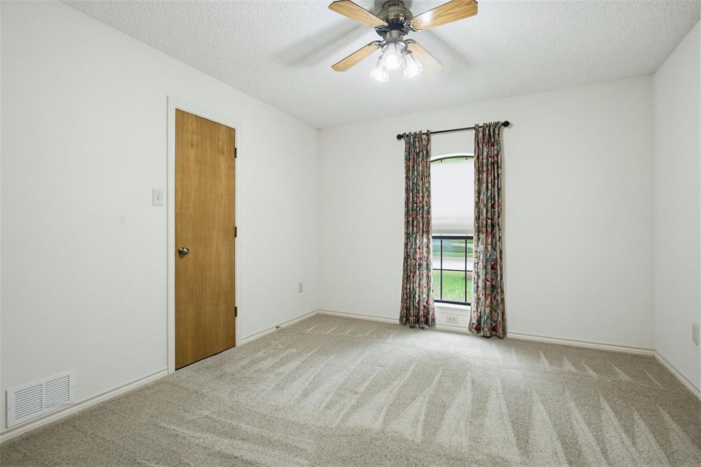 2905 Valleyview Drive Grapevine, TX 76051 - Photo 10 of 12 an empty room with windows and fan