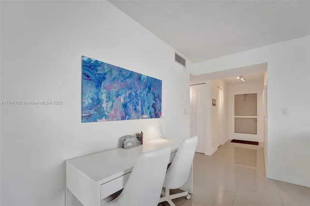 a view of a room that has a table and chairs in it