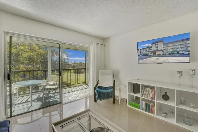 a view of a livingroom with furniture and a large window