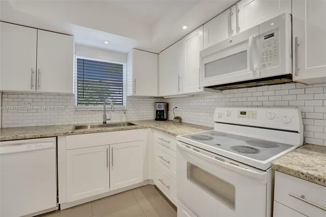 a kitchen with appliances cabinets and a sink