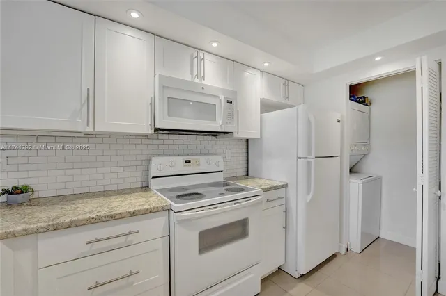 a kitchen with cabinets stainless steel appliances and a counter space