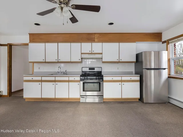 a kitchen with refrigerator and cabinets