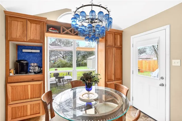 a dining room with furniture a livingroom view and wooden floor