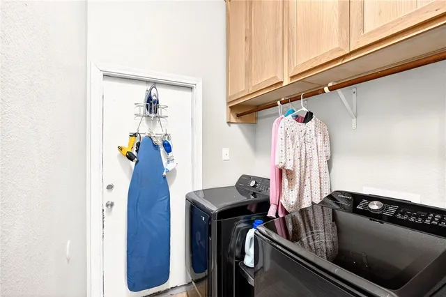 a view of walk in closet with clothes