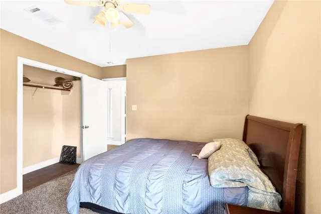 a bedroom with a bed and a mirror