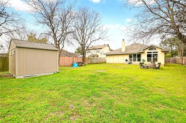 a front view of a house with a big yard and large trees