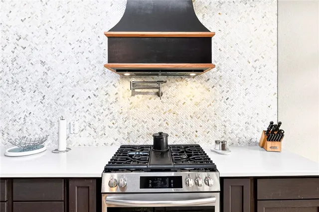 a stove top oven sitting inside of a kitchen