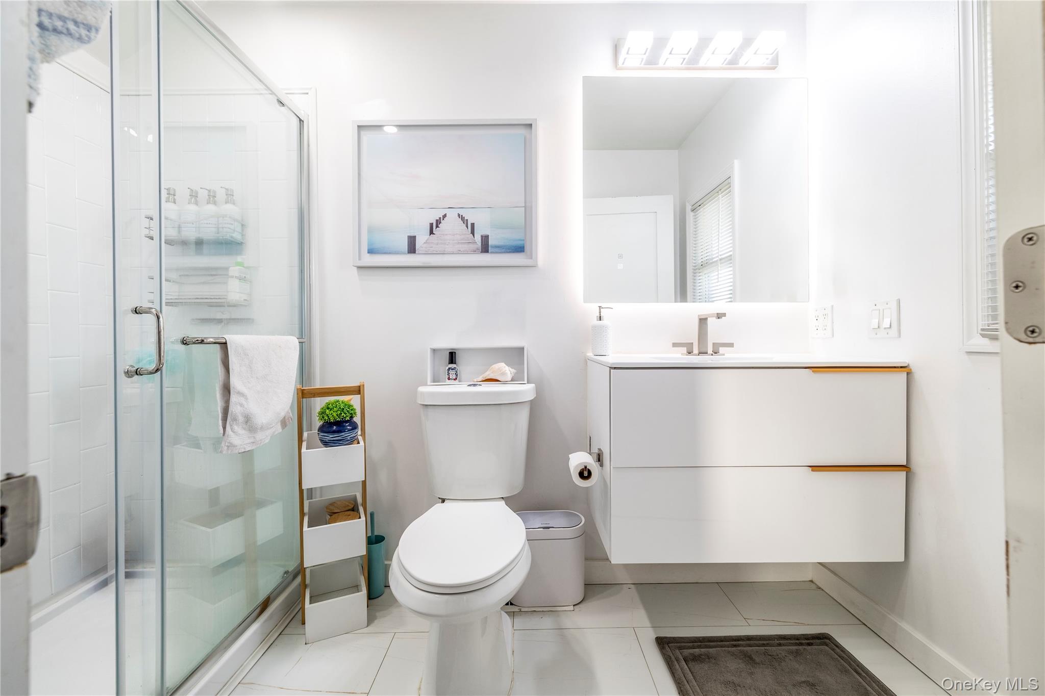 220 Shore Road Seaford, NY 11783 - Photo 15 of 23 a bathroom with a sink a toilet and shower