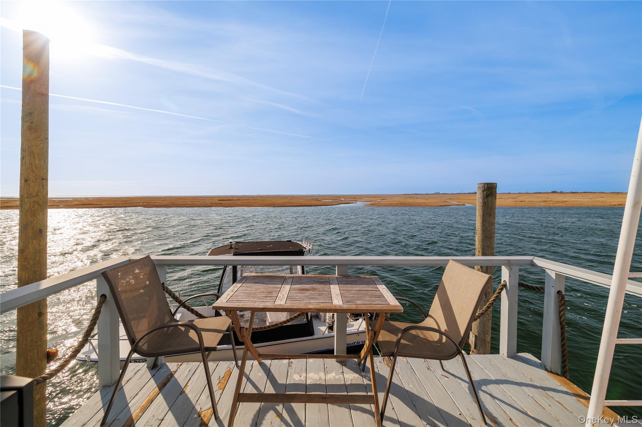 220 Shore Road Seaford, NY 11783 - Photo 19 of 23 a view of a terrace with two chairs and a table