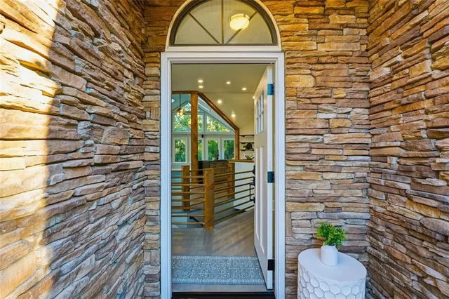 a view of a house with a fireplace and wooden floor