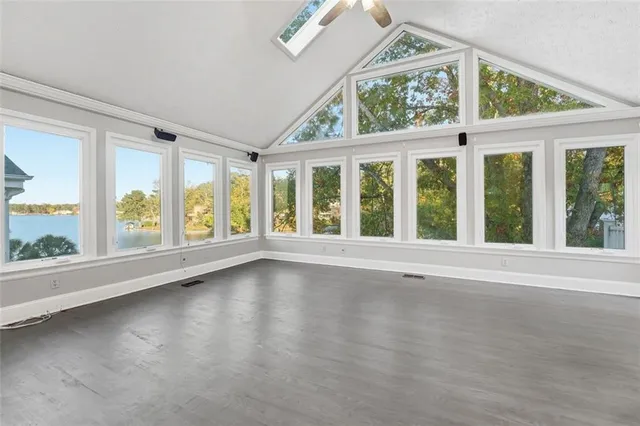 a large kitchen with stainless steel appliances a large counter top a stove a chimney a sink and a large window