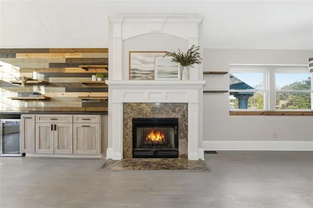 a small white house with a yard and plants