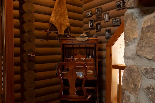 a living room with furniture and large windows