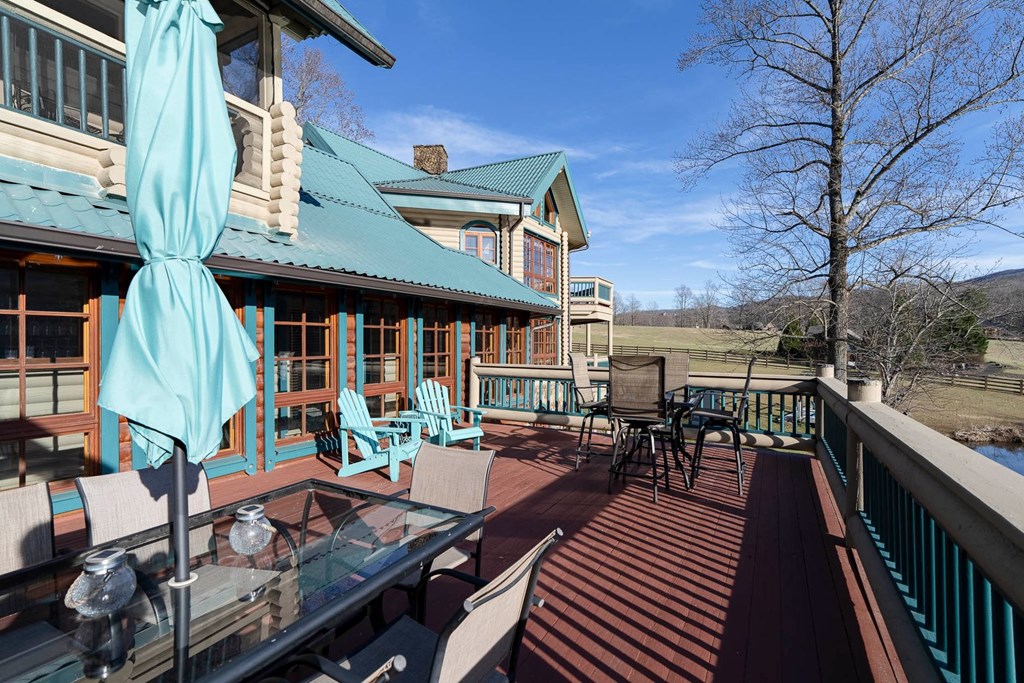 201 Mountainside Parkway Ellijay, GA 30536 - Photo 16 of 78 a view of a patio with couches table and chairs and wooden floor