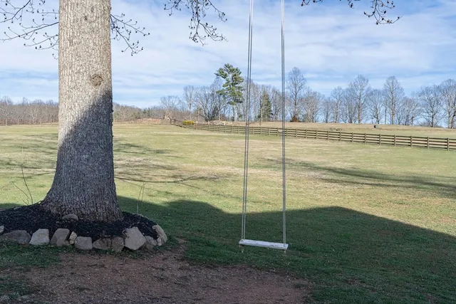 a view of a pathway of a house with a bench
