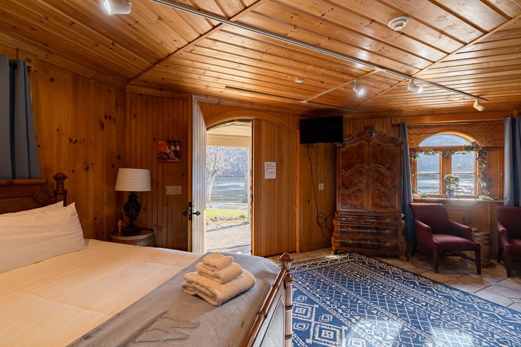 201 Mountainside Parkway Ellijay, GA 30536 - Photo 31 of 78 a bedroom with a bed and wooden floor